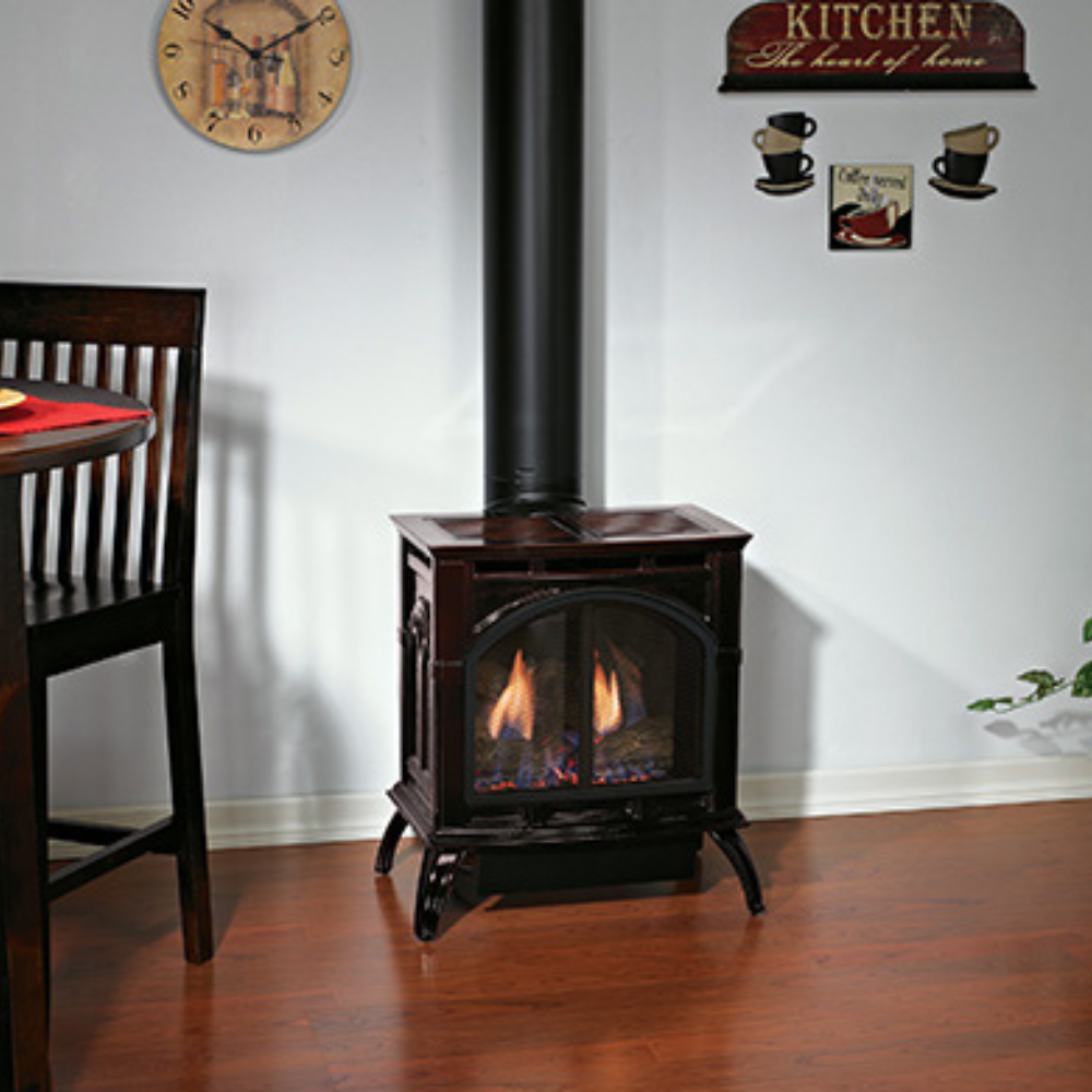 Empire Spirit Small Direct Vent Cast Iron Stove in Porcelain Mahogany Finish near Dining Area