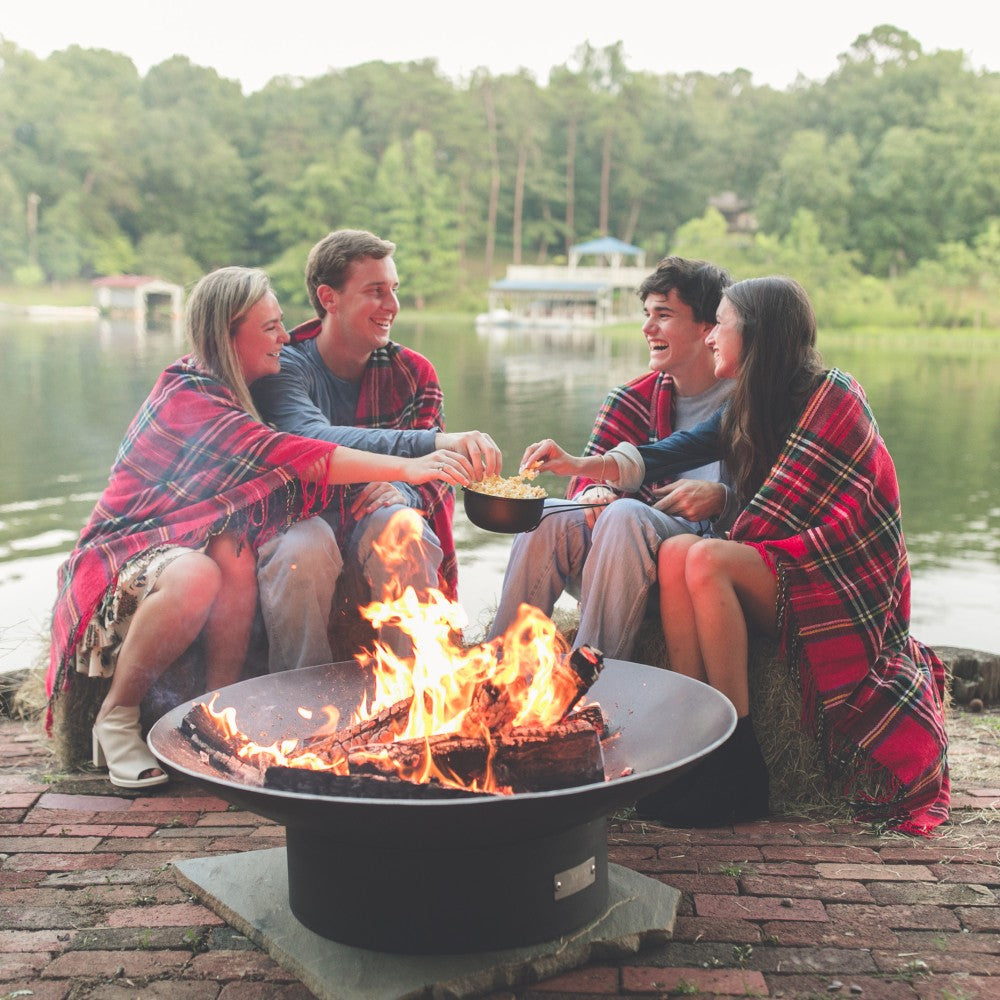 Seasons Fire Pits Concave Round Steel Fire Pit with 4 People at Lake