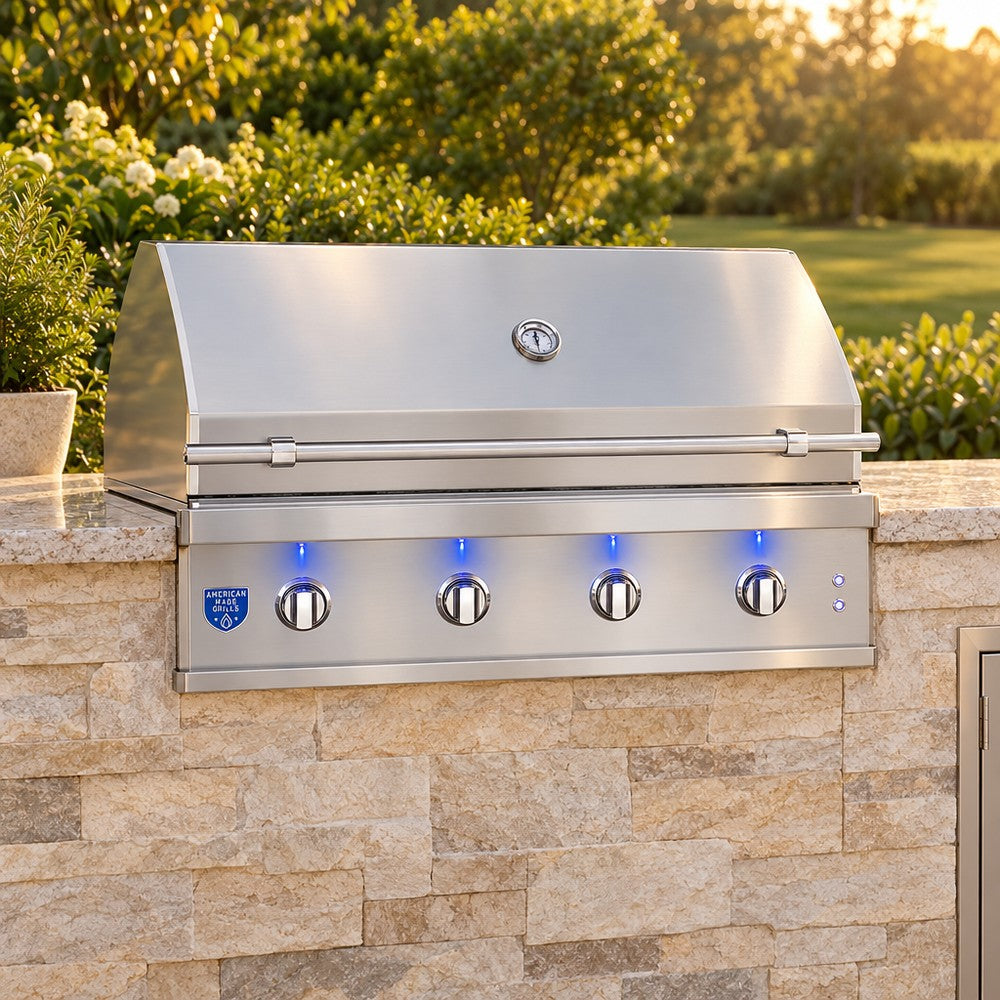 American Made Grills Atlas 42-Inch Built-In Gas Grill in a stone outdoor kitchen island at golden hour