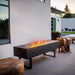 Eco-Feu 29-Inch Drop-in Indoor/Outdoor Ethanol Fireplace Burner in a modern outdoor space on a customized table
