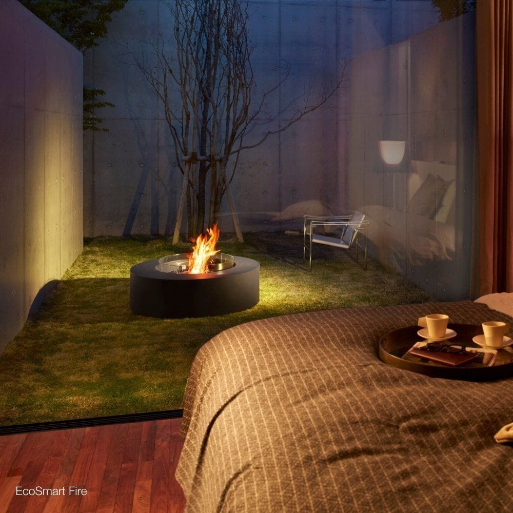 EcoSmart Fire Ark 39-Inch Round Concrete Black Fire Pit Table in an outdoor space