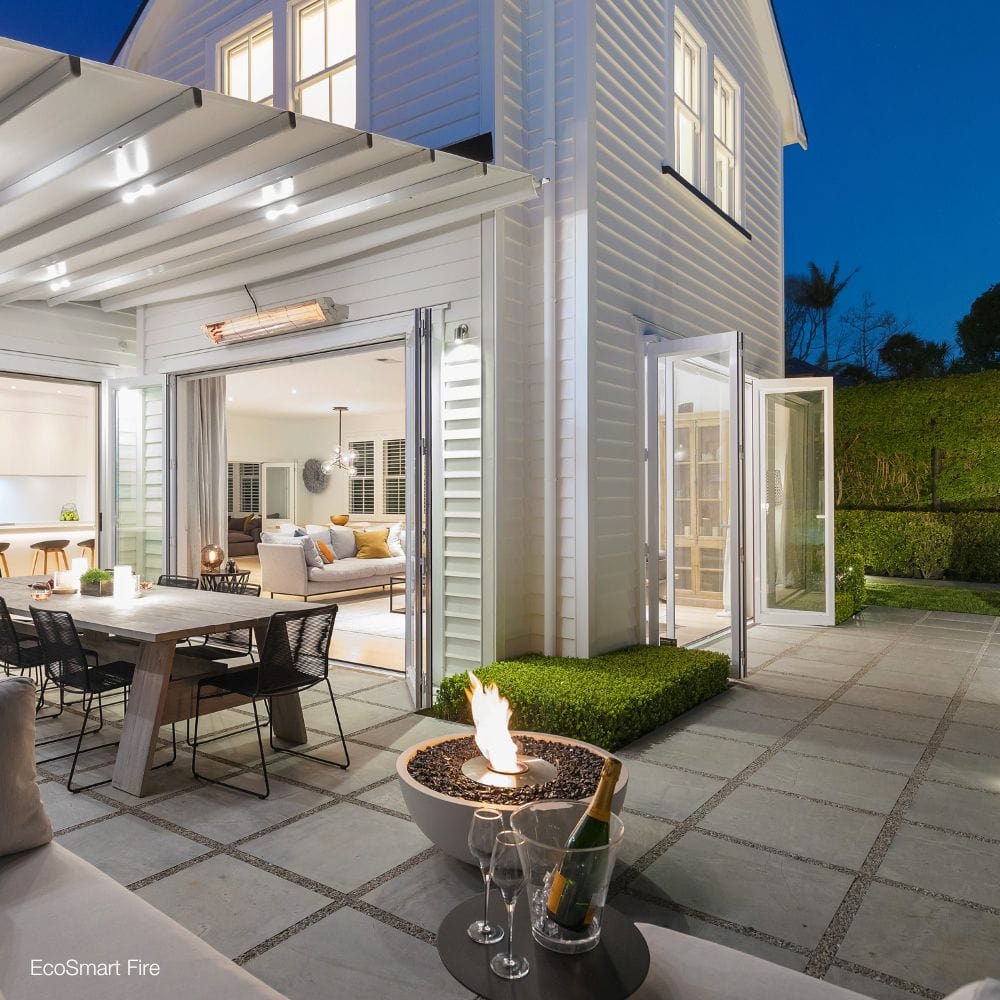 EcoSmart Fire Mix Round Concrete Ethanol Fire Bowl under a pergola