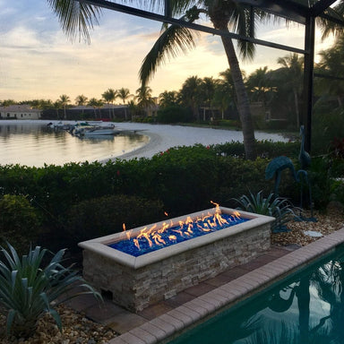 HPC H-Burner Gas Fire Pit Insert installed on a linear fire pit by the lake