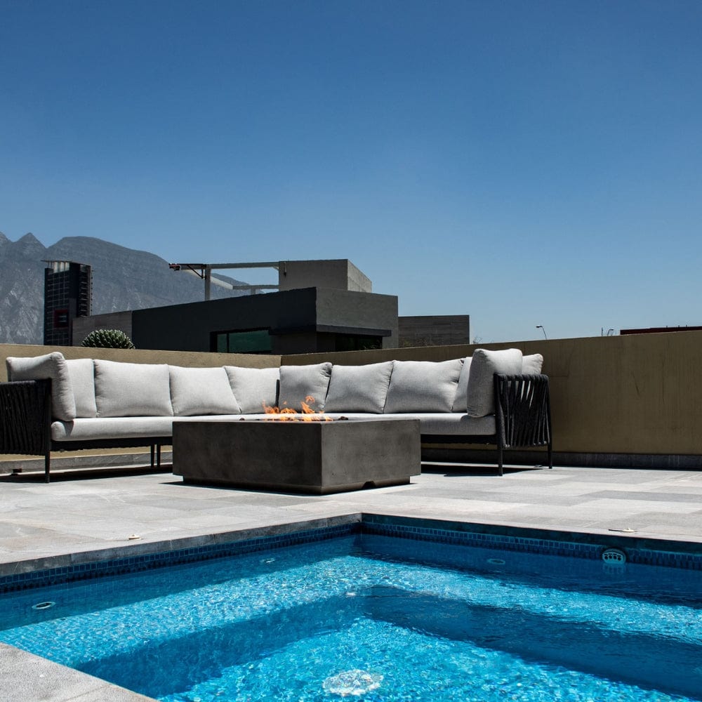 Stonelum Manhattan 01 Rectangular Graphite Fire Pit Table in a pool area