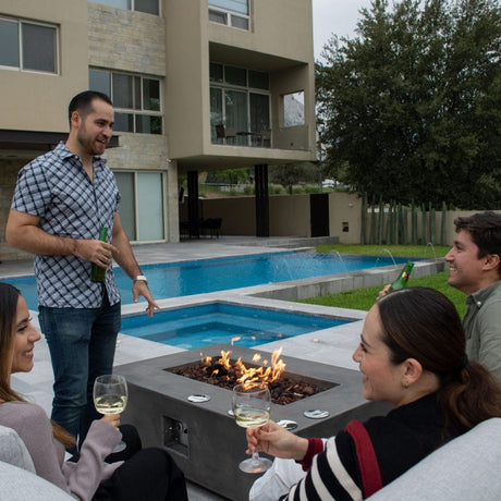 gathering in the pool area with a fire pit table