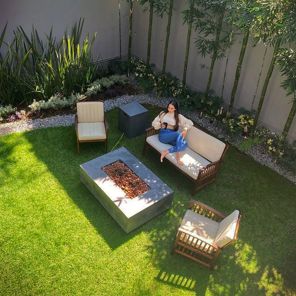 Stonelum Manhattan 01 Rectangular Graphite Fire Pit Table in a garden