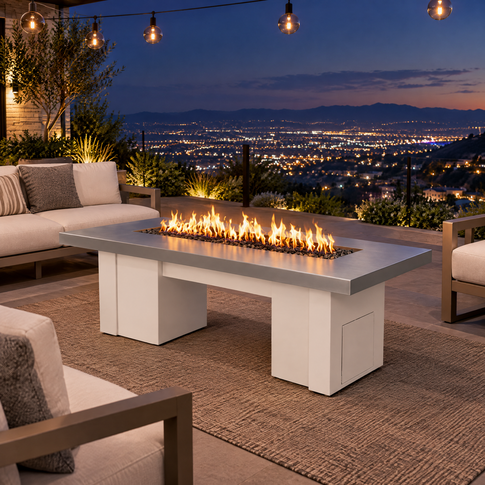 Top Fires Alameda 72-inch GFRC gas fire table with a Metallic Silver tabletop and White base on a hillside patio overlooking city lights