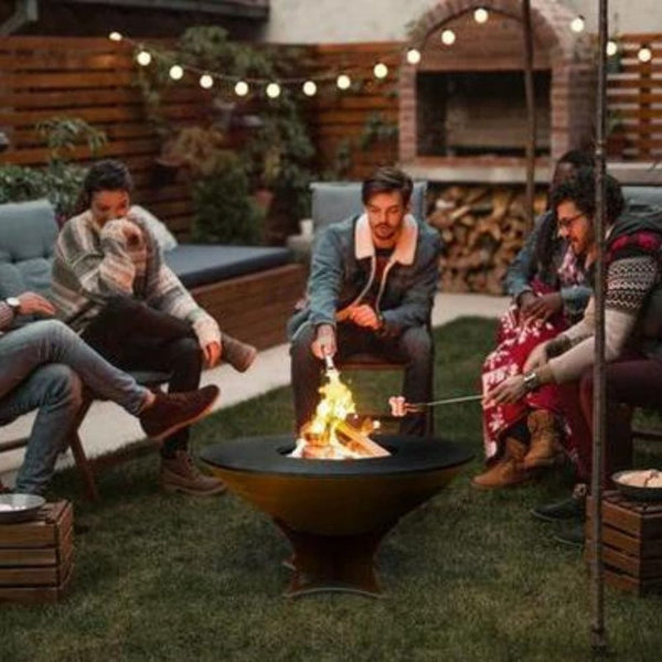 roasting marshmallows with friends on the arteflame low euro base fire pit