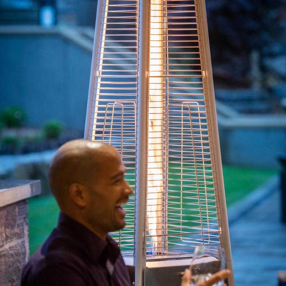 Crown Verity Quartz Tube Patio Heater Beside Laughing Man