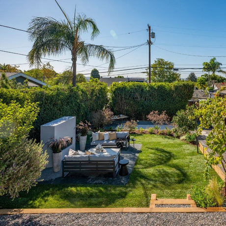 firegear kalea bay vent free gas fireplace with white surround in modern backyard