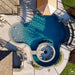 Birds eye view of pool area with round sanctuary fire pit
