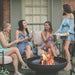 gathering around the Seasons Fire Pits Elliptical Round Steel Fire Pit with friends