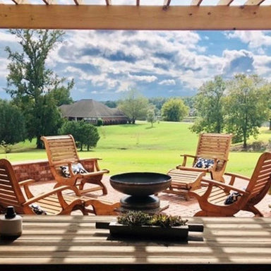 Seasons Fire Pits Vulcan Round Steel Fire Pit under a pergola