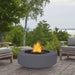 Gray  Round Fire Pit in Patio with Chairs and Trees