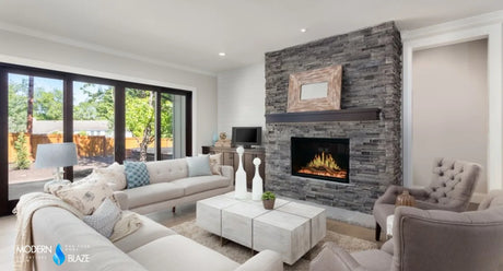 Large open living room with a lit stone fireplace, the kind of space a BTU calculation sizes