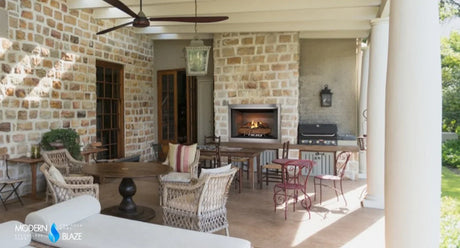 Modern outdoor fireplace on a stone patio at dusk