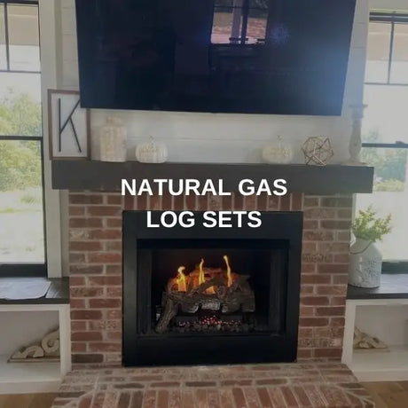 Natural gas log set burning in a brick fireplace below a mounted TV