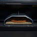 Green Mountain Grills Wood-Fired Pizza Oven with Pizza being cooked