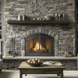 flat sawn beam roasted chestnut mantel on a gray stone wall