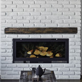 hayloft beam maduro mantel on a white brick wall