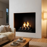 Majestic Contemporary vented gas burner with cannonballs burning in a white plaster fireplace in a Scandinavian-style living room