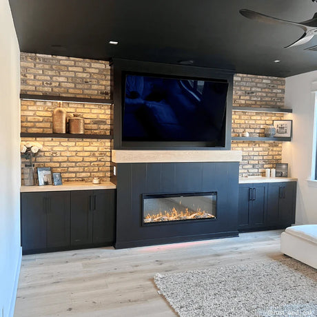 Modern living room with a fireplace, television, and brick wall.