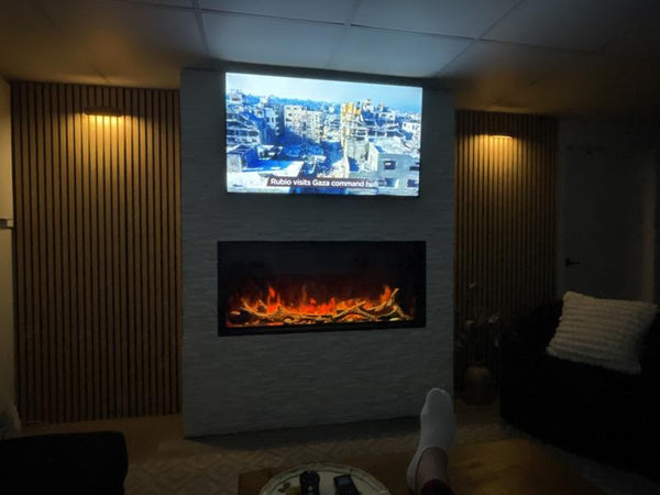 Living room with a TV displaying a cityscape and an electric fireplace.