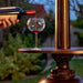 pouring wine into a glass placed on the patio comfort pc02cab vintage propane patio heater