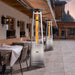 Paragon Outdoor Vesta Flame Tower Patio Heater in Stainless Steel at a cafe