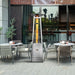 Paragon Outdoor Vesta Flame Tower Patio Heater in Stainless Steel on a restaurant's patio