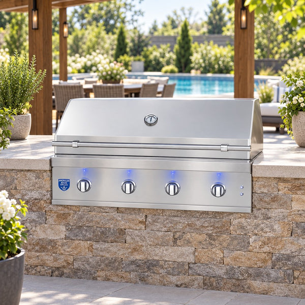 American Made Grills Atlas 42-Inch Built-In Gas Grill built into a stacked stone island on a backyard patio under a pergola
