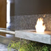 EcoSmart Fire BK5 16" Ethanol Fireplace Burner in Custom Fire Table beside a fountain