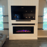 Touchstone Sideline 60 electric fireplace in a white shiplap media wall with floating shelves and a TV