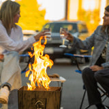 Live Outdoor Firestorm Series I Portable Propane Fire Pit being used in an outdoor gathering.