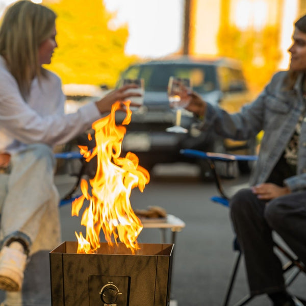 Live Outdoor Firestorm Series I Portable Propane Fire Pit being used in an outdoor gathering.