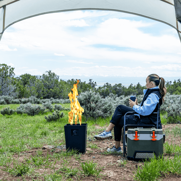 Enjoy the Live Outdoor Firestorm Series I Fire Pit with the Burner On at an Outside Campsite Amidst Beautiful Scenery