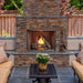 majestic courtyard fireplace with brown herringbone panel in a cozy patio setting