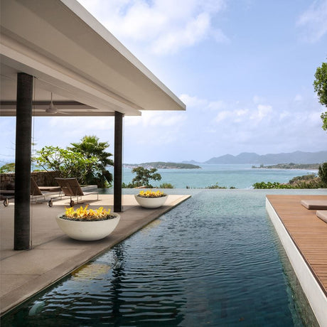 modern blaze white gas fire bowl near a water feature