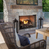 Majestic Vesper outdoor fireplace with the Lumonessen burner and logs lit on a covered deck
