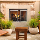 Majestic Vesper outdoor fireplace with optional mesh doors on a garden patio