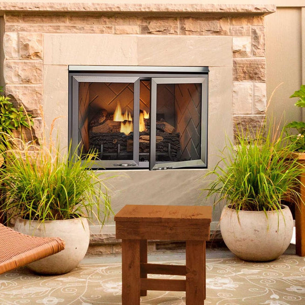 Majestic Vesper outdoor fireplace with optional mesh doors on a garden patio
