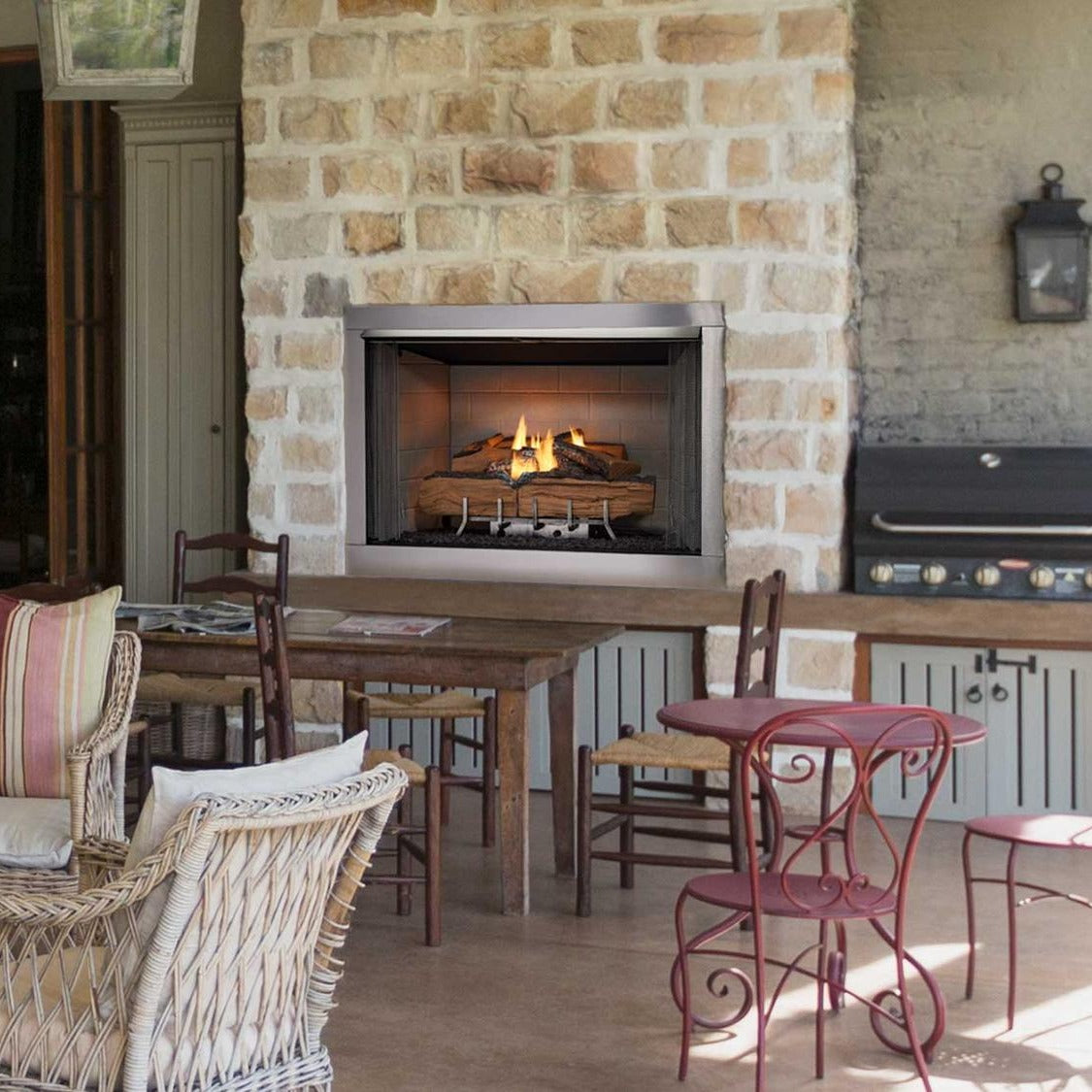 Majestic Vesper outdoor fireplace beside an outdoor kitchen on a covered patio