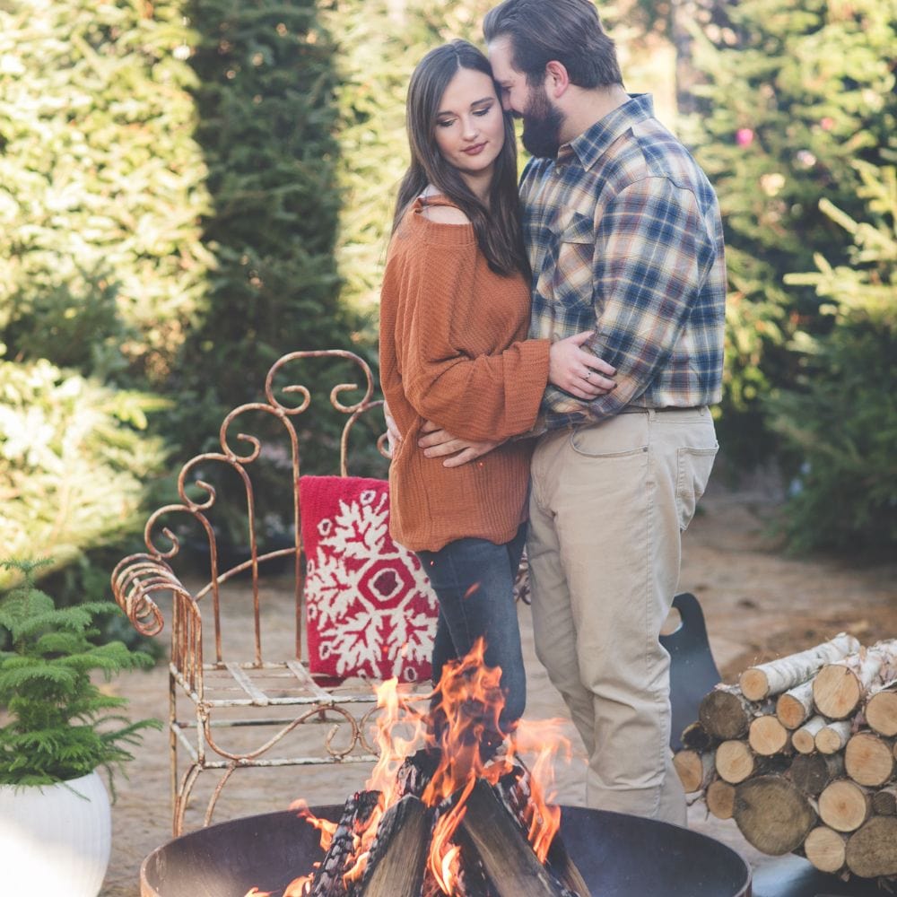couple spending time by the seasons fire pits elliptical steel fire pit