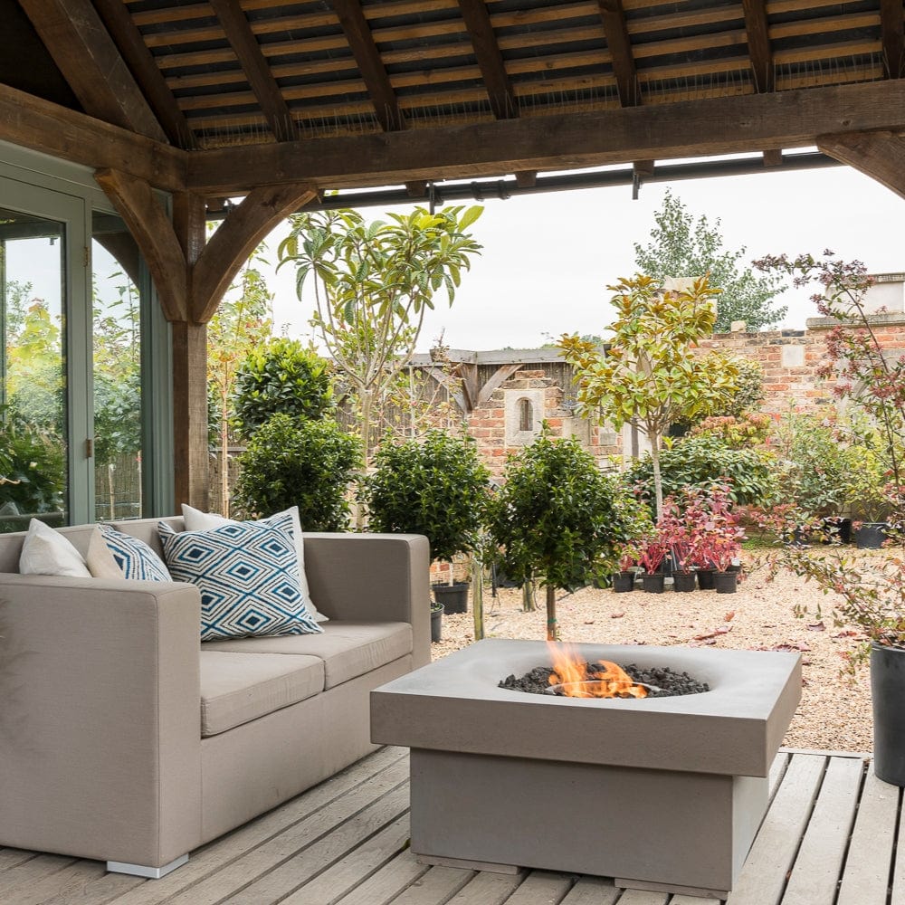 Solus Elevated Halo 36-Inch Square Gas Fire Pit beside a couch