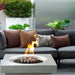 white solus elevated halo square gas fire pit beside a couch