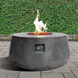Stonelum Indiana 01 47-Inch Round Graphite Gas Fire Pit in a garden