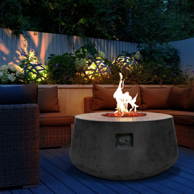 Stonelum Indiana 01 47-Inch Round Graphite Gas Fire Pit in a cozy patio setting