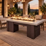 Top Fires Alameda 72-inch GFRC gas fire table with a Metallic Pearl tabletop and Copper Vein base in an elegant covered stone loggia set for dinner