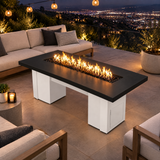 Top Fires Alameda 72-inch GFRC gas fire table with a Smooth Black tabletop and White base on a hillside patio overlooking city lights