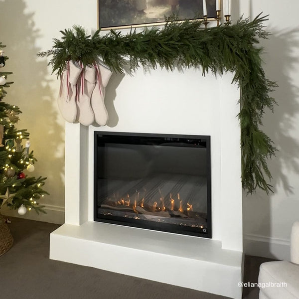 Touchstone Fireplug PRO electric fireplace insert 33-inch installed in a mantel dressed for the holidays